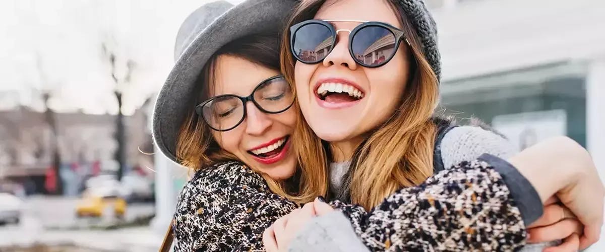 Two girls embracing warmly in Munich, showcasing friendship and joy